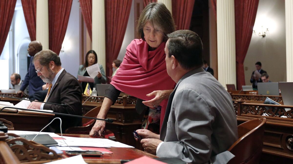 State Sen. Nancy Skinner (D-Berkeley) talks with Sen. Joel Anderson (R-Alpine) during the Senate session.