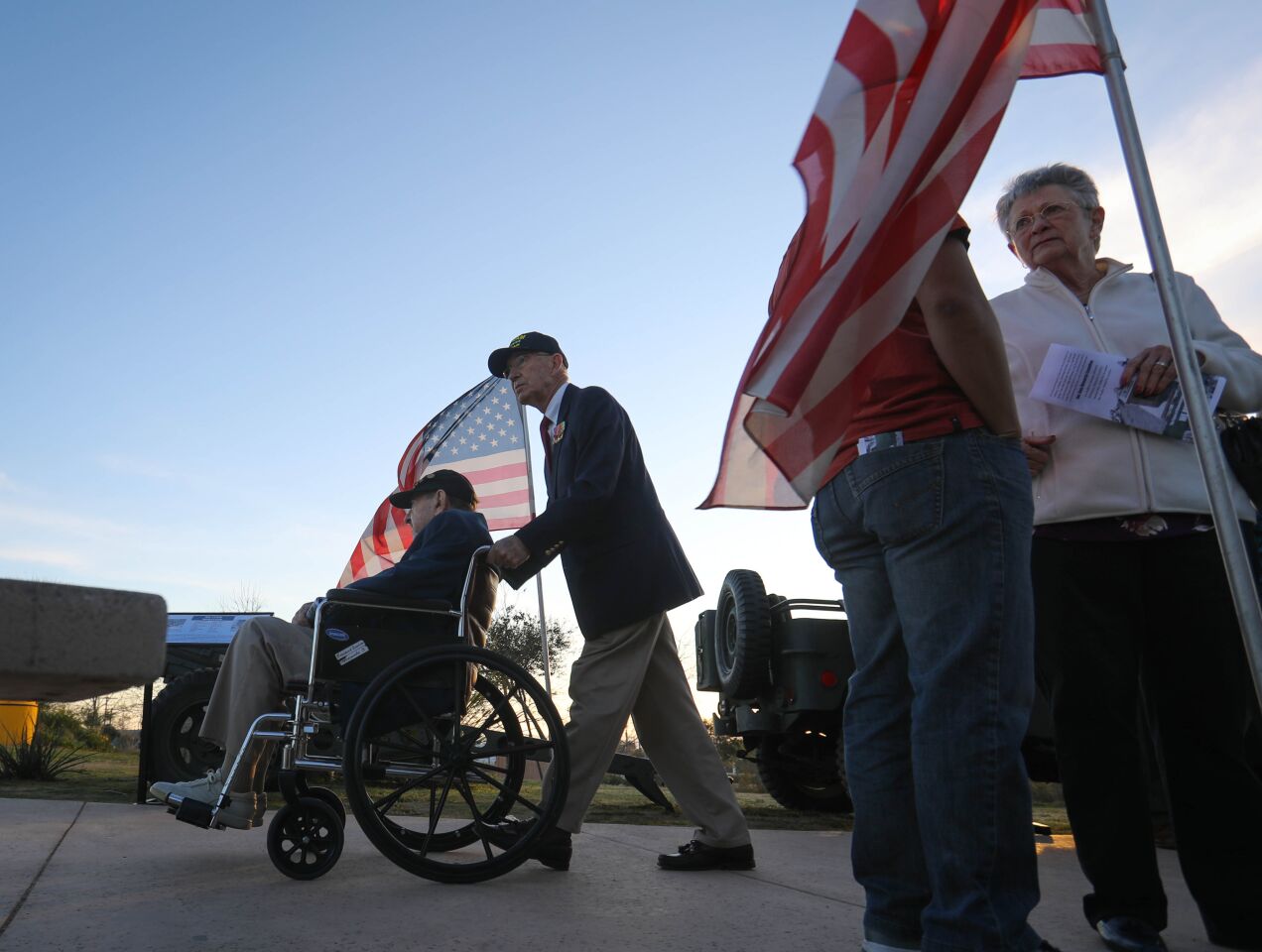 World War II Navy veteran of the Battle of Iwo Jima, Mort Block, of Carlsbad, is pushed by Marine Corps Vietnam veteran Nick Pereira, also from Carlsbad, during the commemoration ceremony for the 75th anniversary of the battle, at Camp Pendleton, February 15. This is the last time the Iwo Jima Commemorative Committee is planning to hold a formal West Coast gathering of veterans of the battle.