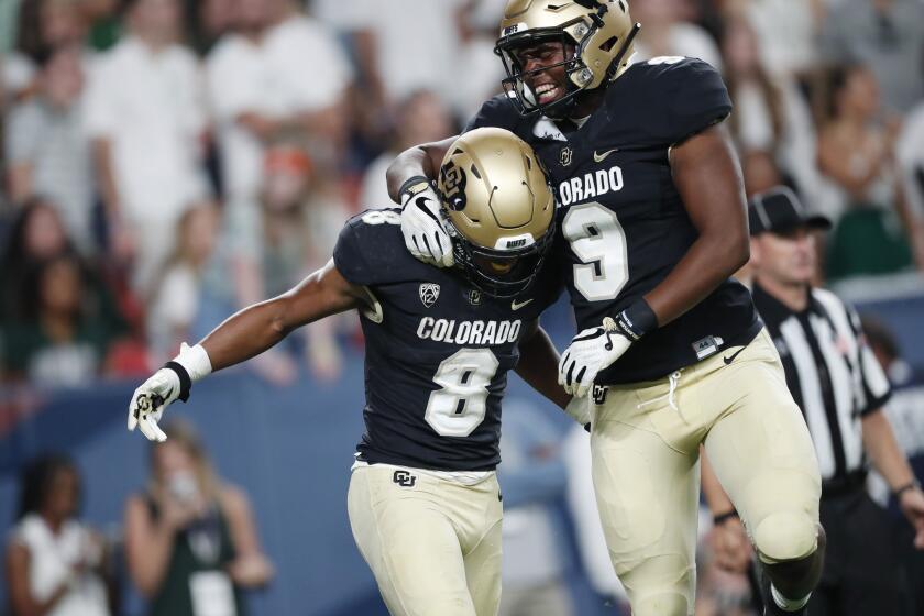 Colorado tight end Jalen Harris, right, celebrates with running back Alex Fontenot, who scored a touchdown against Colorado State in the third quarter of an NCAA college football game Friday, Aug. 30, 2019, in Denver. (AP Photo/David Zalubowski)