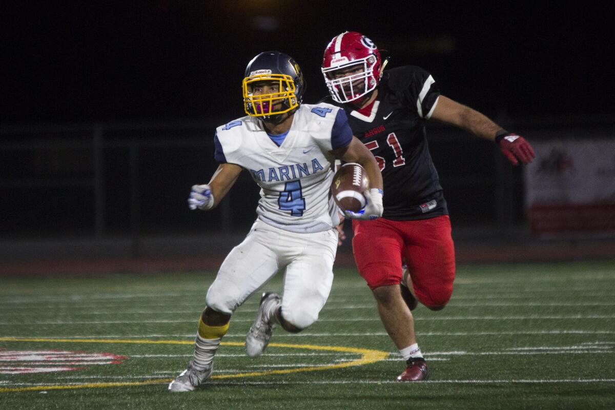 Marina's Pharoah Rush, shown running the ball at Garden Grove High on Oct. 31, helped the Vikings win their first league title since 1986.