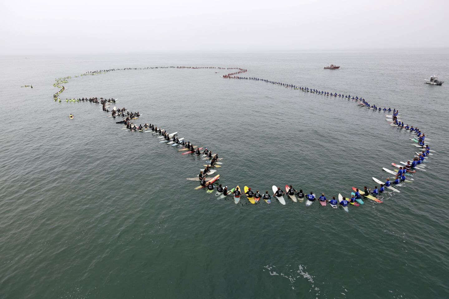 Surfers set a mark recognized by the Guinness World Records for the largest paddle-out on International Surfing Day.