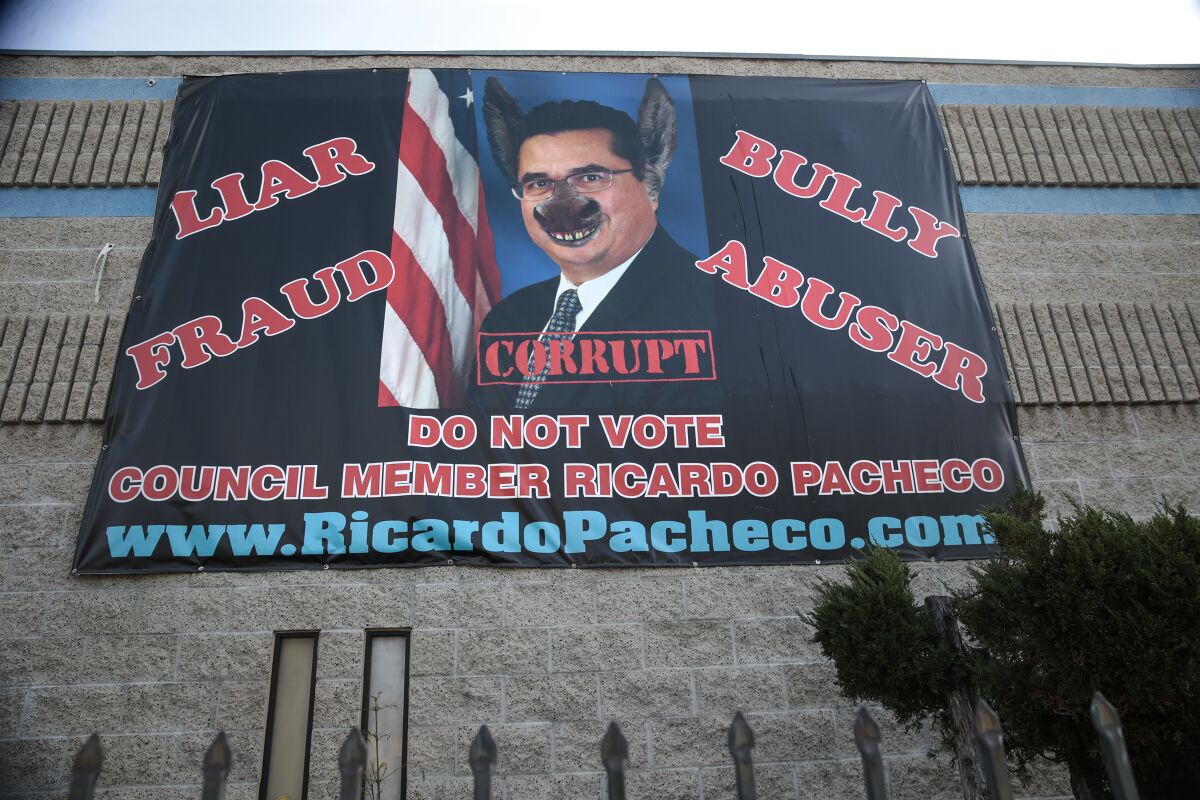 A banner portraying Ricardo Pacheco as a "jackass."