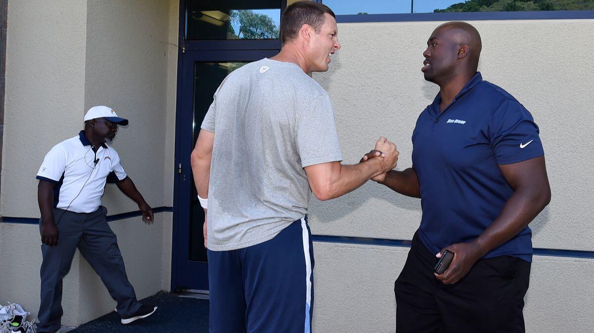 Chargers quarterback Philip Rivers, left, shakes hands with former Charger Jacques Cesaire after a minicamp held at the Chargers facility Thursday.