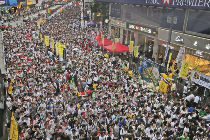 Pro-democracy marchers fill the streets in Hong Kong for an annual protest on Tuesday.