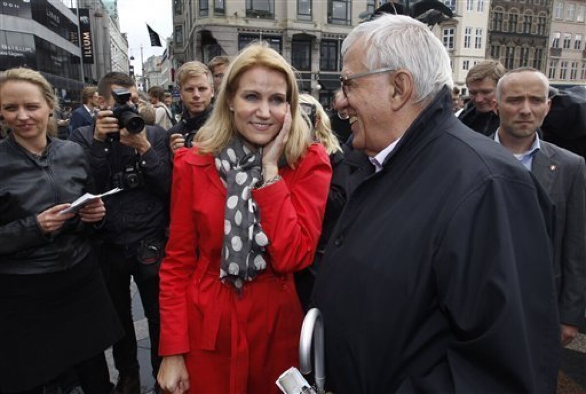 Danish opposition leader Helle Thorning-Schmidt of the Social Democrats, left, and Villy Soevndahl of the Socialist People's Party, right, in the streets of Copenhagen, Denmark, Wednesday, Sept. 14, 2011. Polls show Denmark's left-leaning Social Democrats could return to power after a decade in opposition, making party leader Helle Thorning-Schmidt the country's first female prime minister. (AP Photo/PolfotoJens Dresling) DENMARK OUT