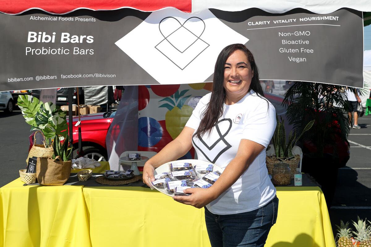 Bibi Bars owner Bibiana Burciaga, 42, of Newport Beach sells probiotic bars Saturday during the O.C. Swap Meet in Costa Mesa.