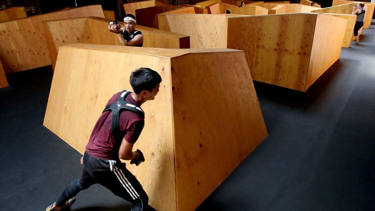 Avoiding opponents in the maze can be an intense workout. (Luis Sinco / Los Angeles Times)