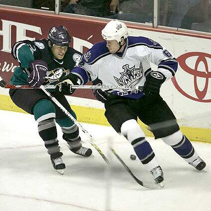 GOTTA GO: Joseph Corvo of the Kings tries to skate away from the Mighty Ducks' Todd Marchant.