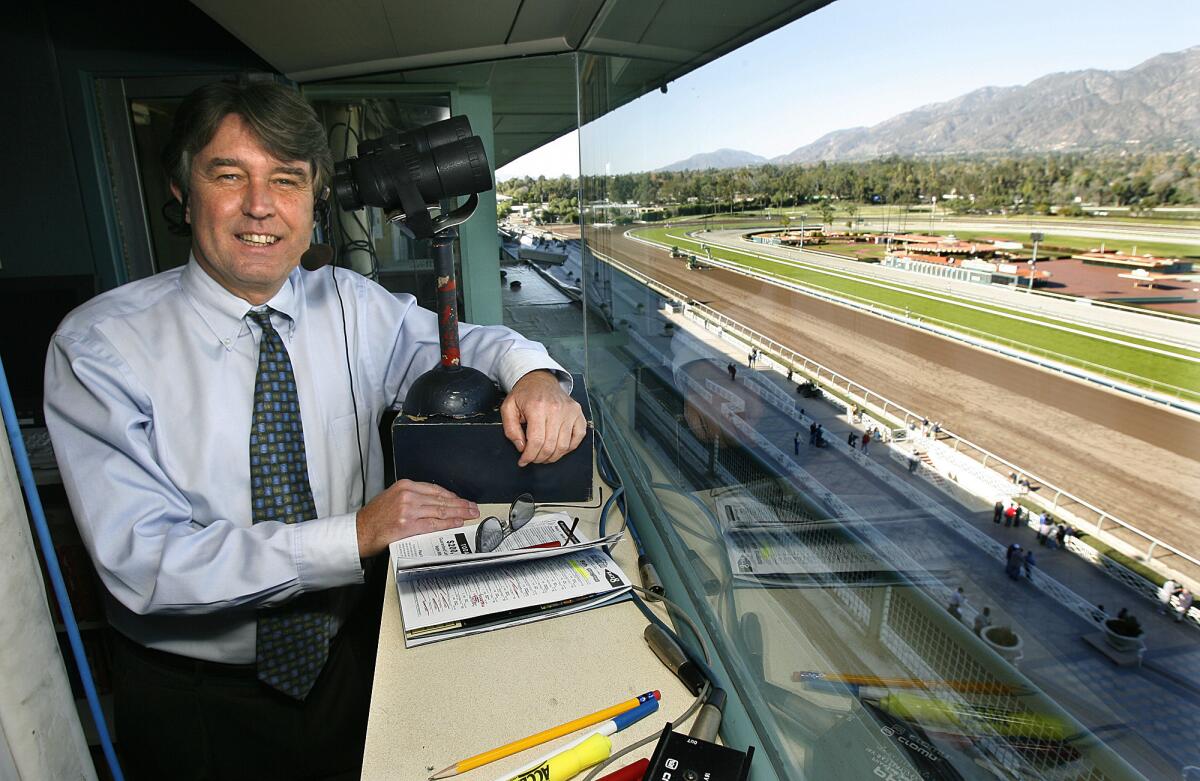 Race track announcer Trevor Denman stands in the booth at Santa Anita in 2007. He has called races at the track for 33 years.