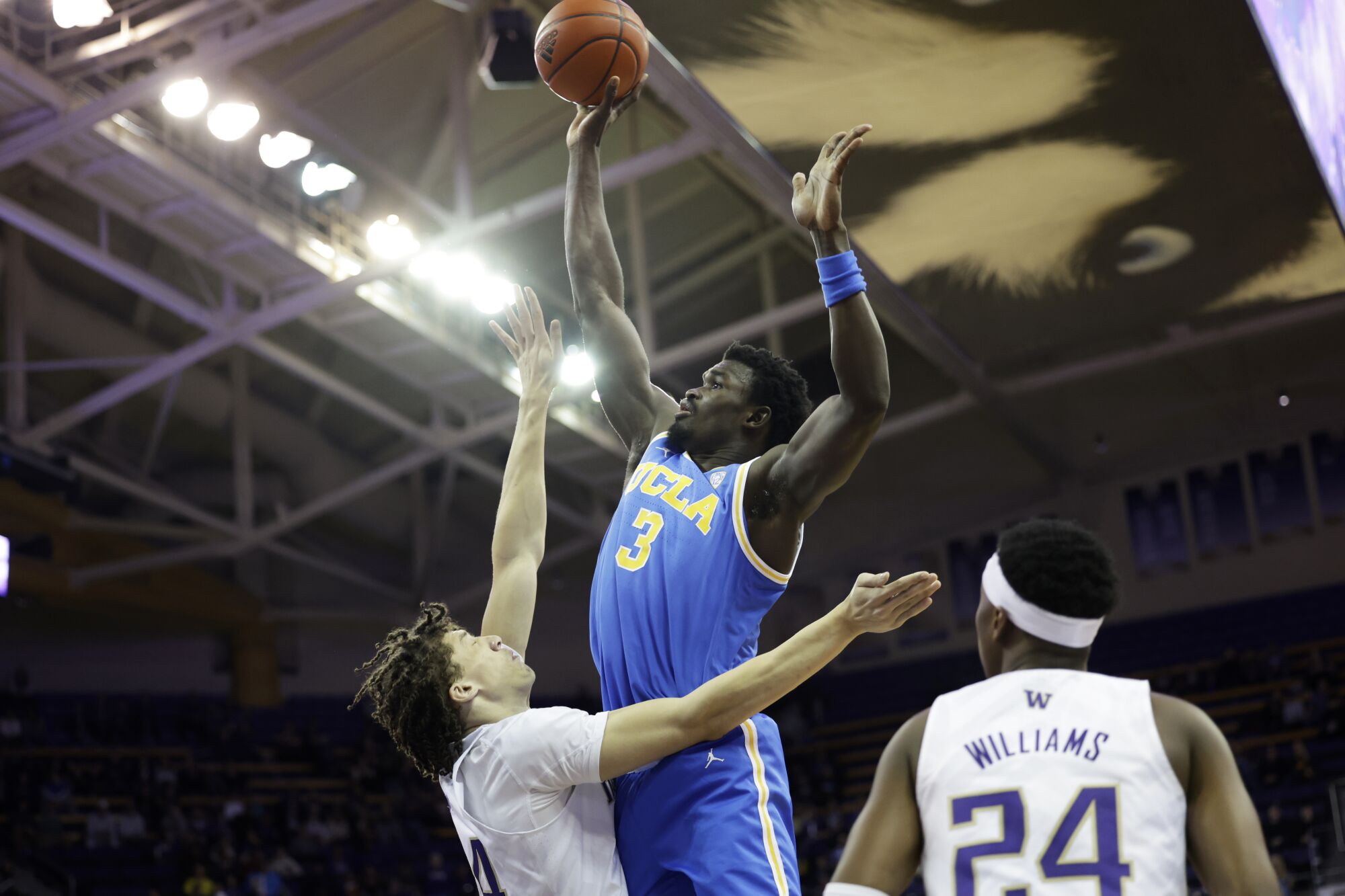 UCLA center Adem Bona shoots over Washington center Braxton Meah on Jan. 1, 2023.