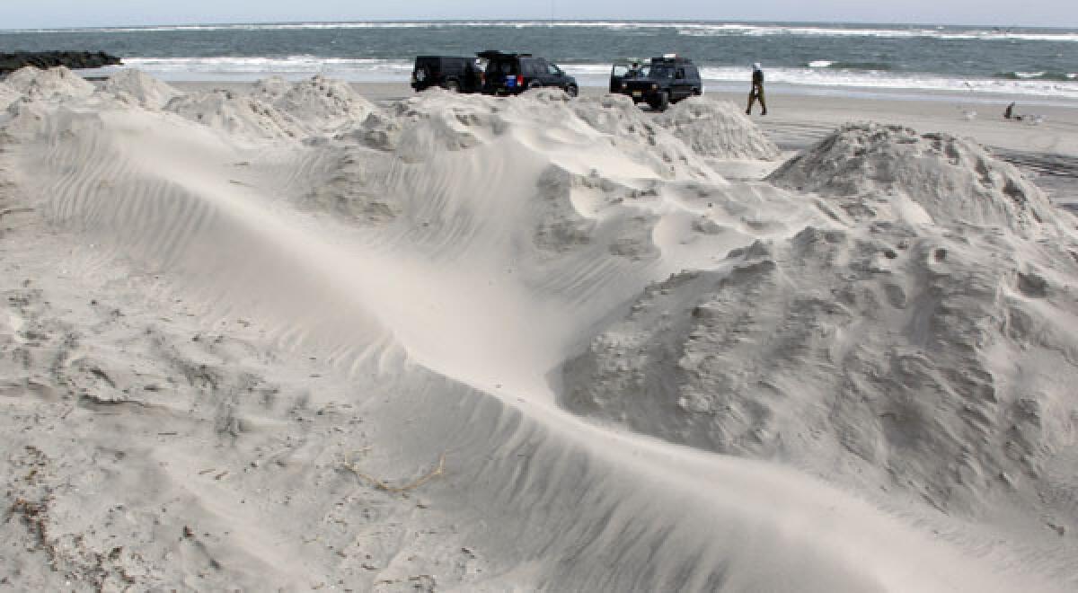 Sand mounds on the beach provide a buffer as North Wildwood, N.J., prepares for Sandy.