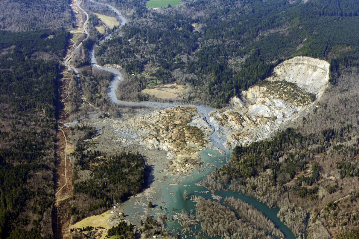 This aerial photo, taken Monday, shows the massive mudslide that killed at least eight people Saturday and left dozens missing near Arlington, Wash.