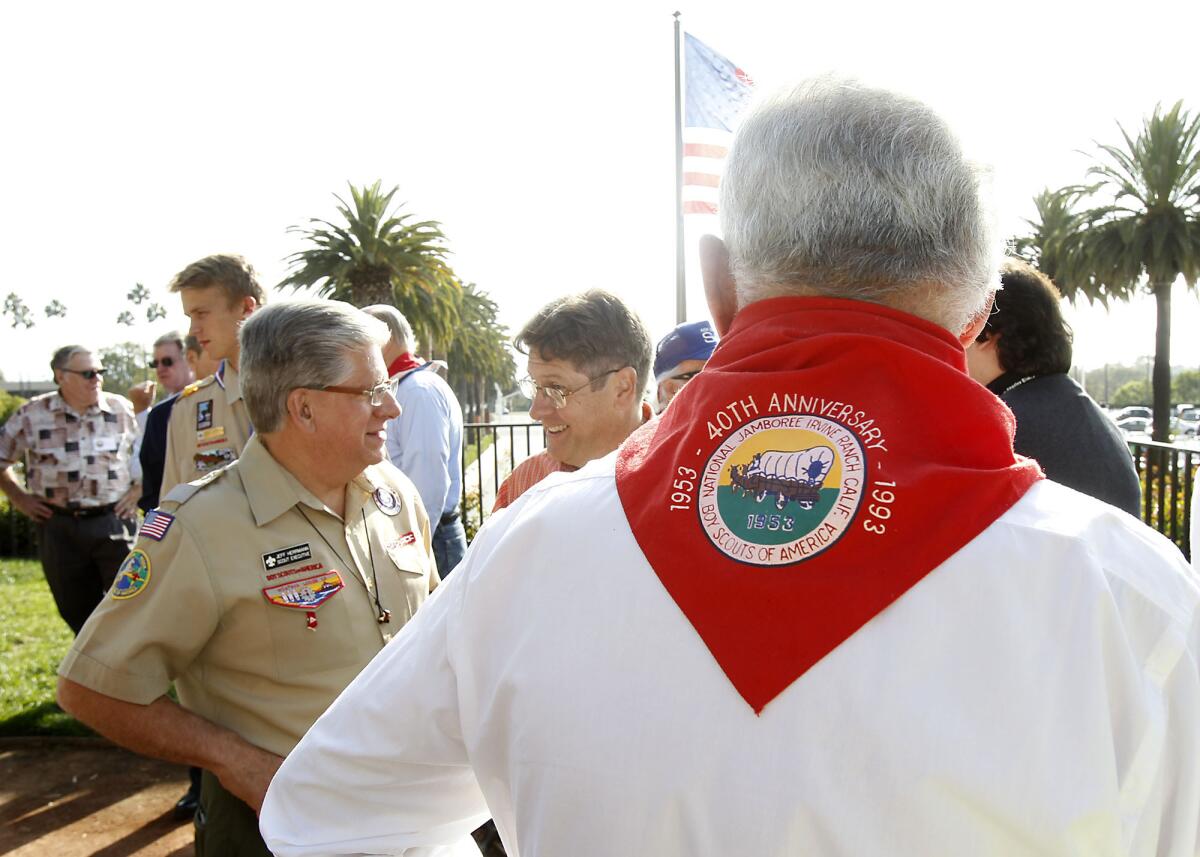 Members past and present including Larry Locy with red scarf, gather to remember the 1953 Boy Scouts of America Jamboree during 50th anniversary celebration that took place at Fashion Island on Thursday. The area was formerly Irvine Ranch land.