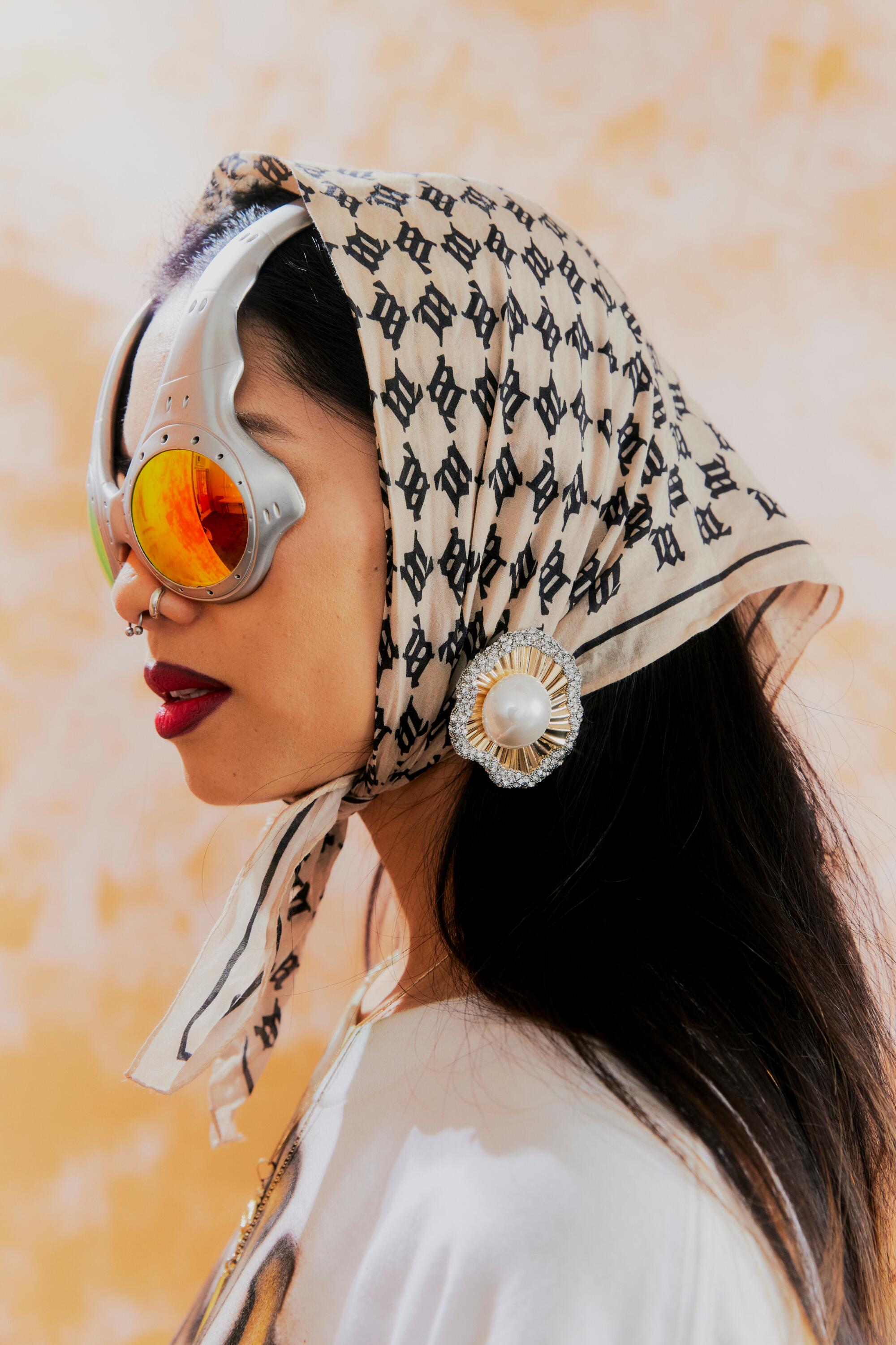 Ann-Marie Hoang in profile wearing a headscarf and Over the Top sunglasses.
