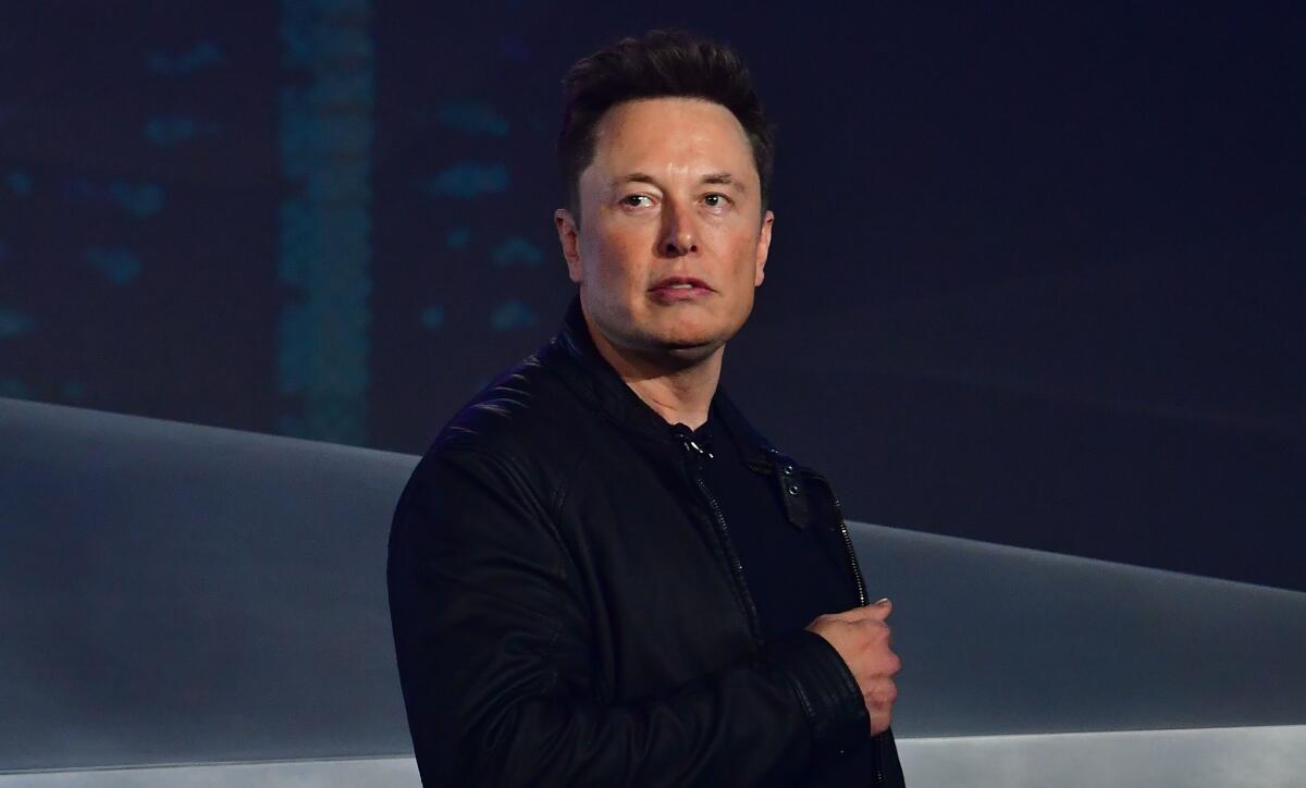 Elon Musk looks to his right.