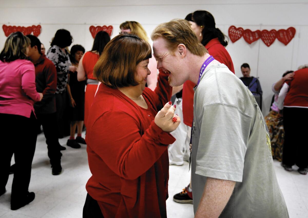 Sandy Saenz, left, and Michael Riley are all smiles at the annual Valentine's Day "Sweetheart Dance" for disabled adults at the McCambridge Recreation Center in Burbank.