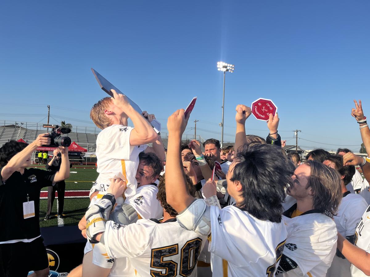 Foothill's Luke Fox kisses the trophy after the Knights beat Loyola for the Southern Section Division 1 title May 12, 2023.