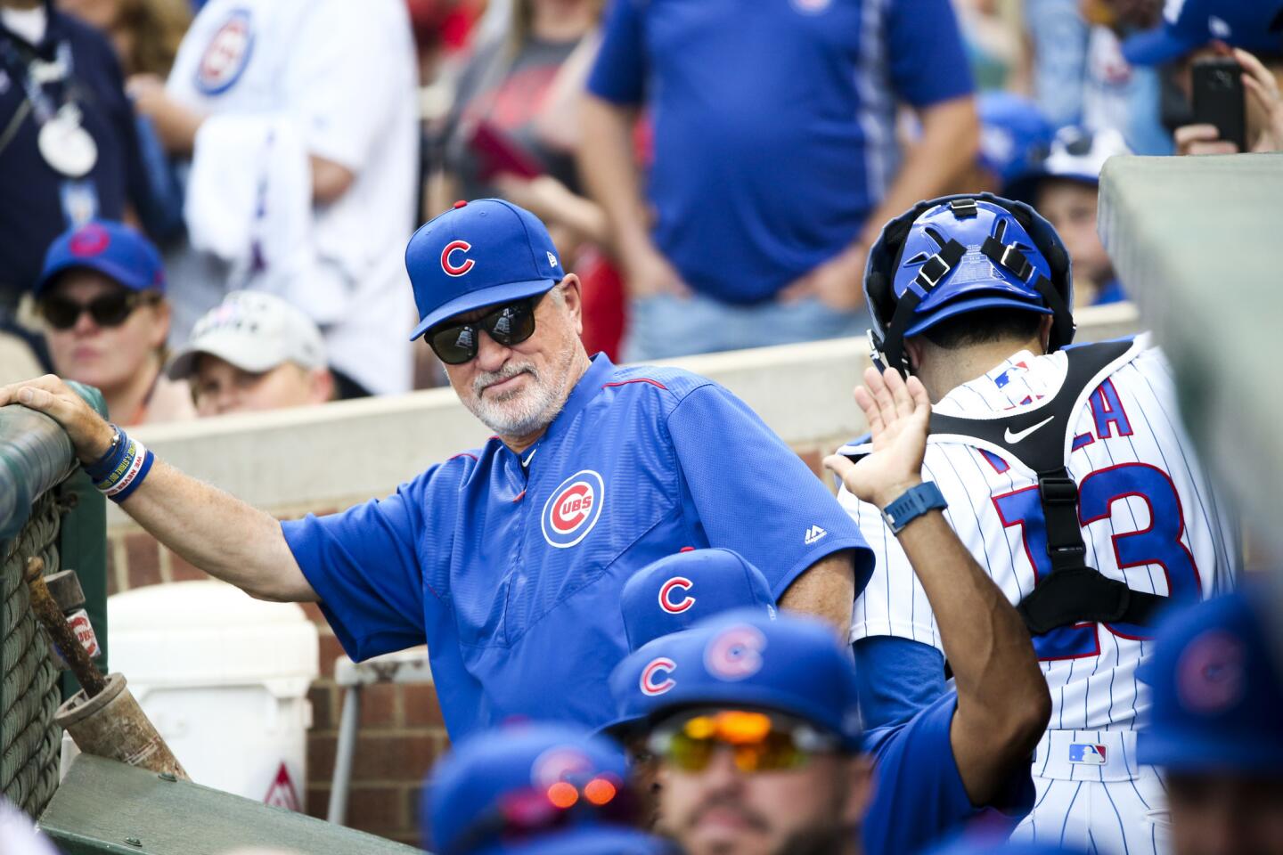 Cubs manager Joe Maddon stands in the dugout before the first inning against the Cardinals at Wrigley Field on Sunday, Sept. 17, 2017.