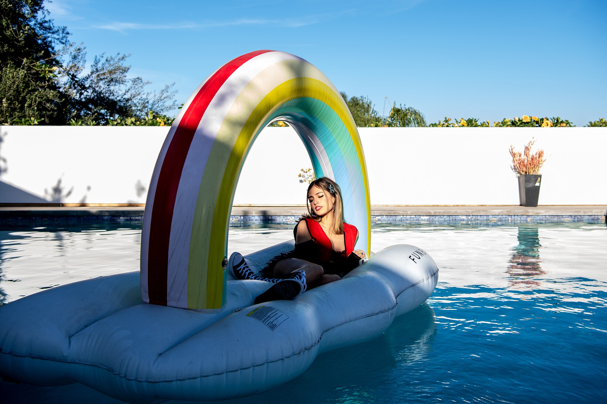Isabella Ferregur floats on a floaty in the pool.