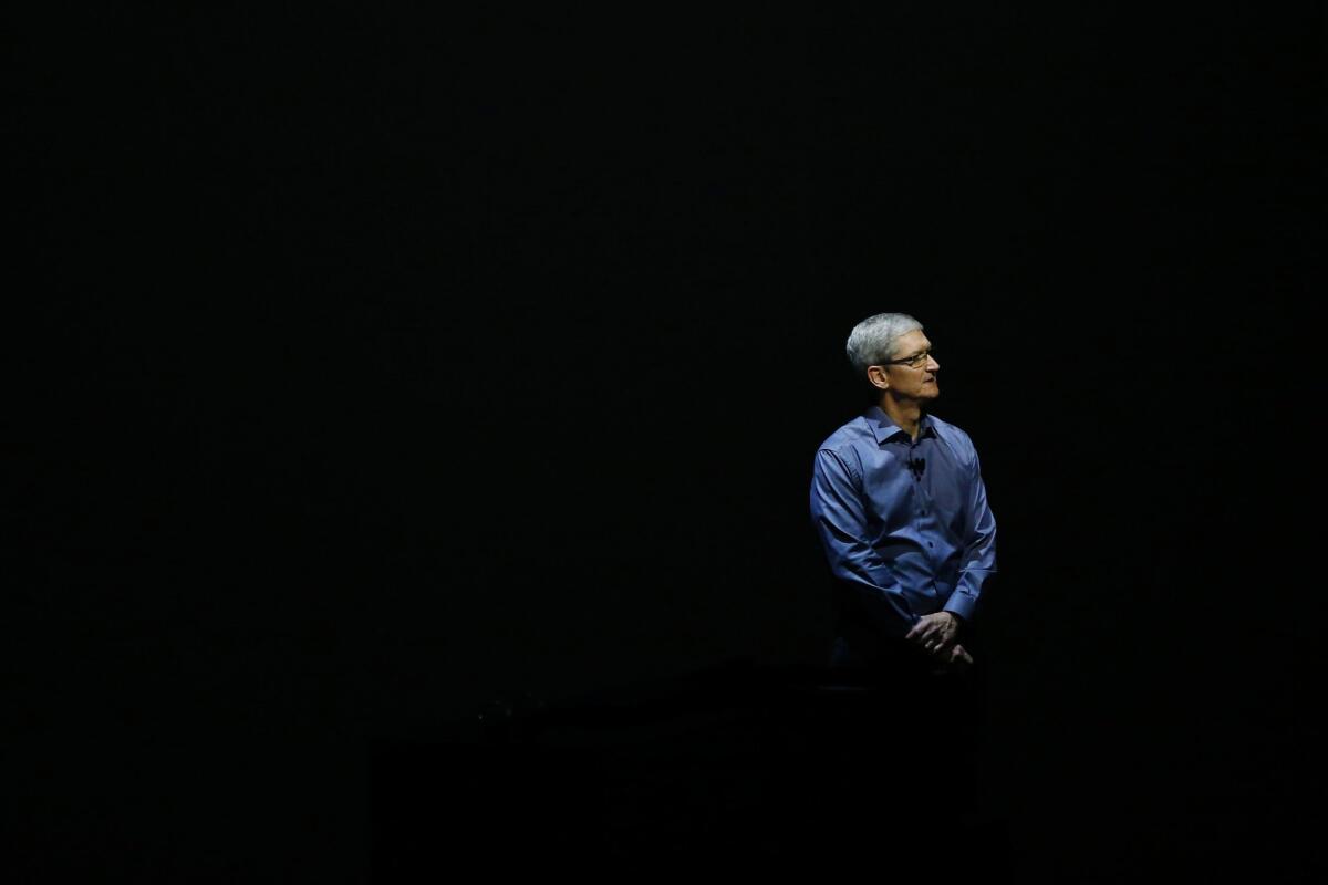 Apple CEO Tim Cook stands on stage in San Francisco in September.