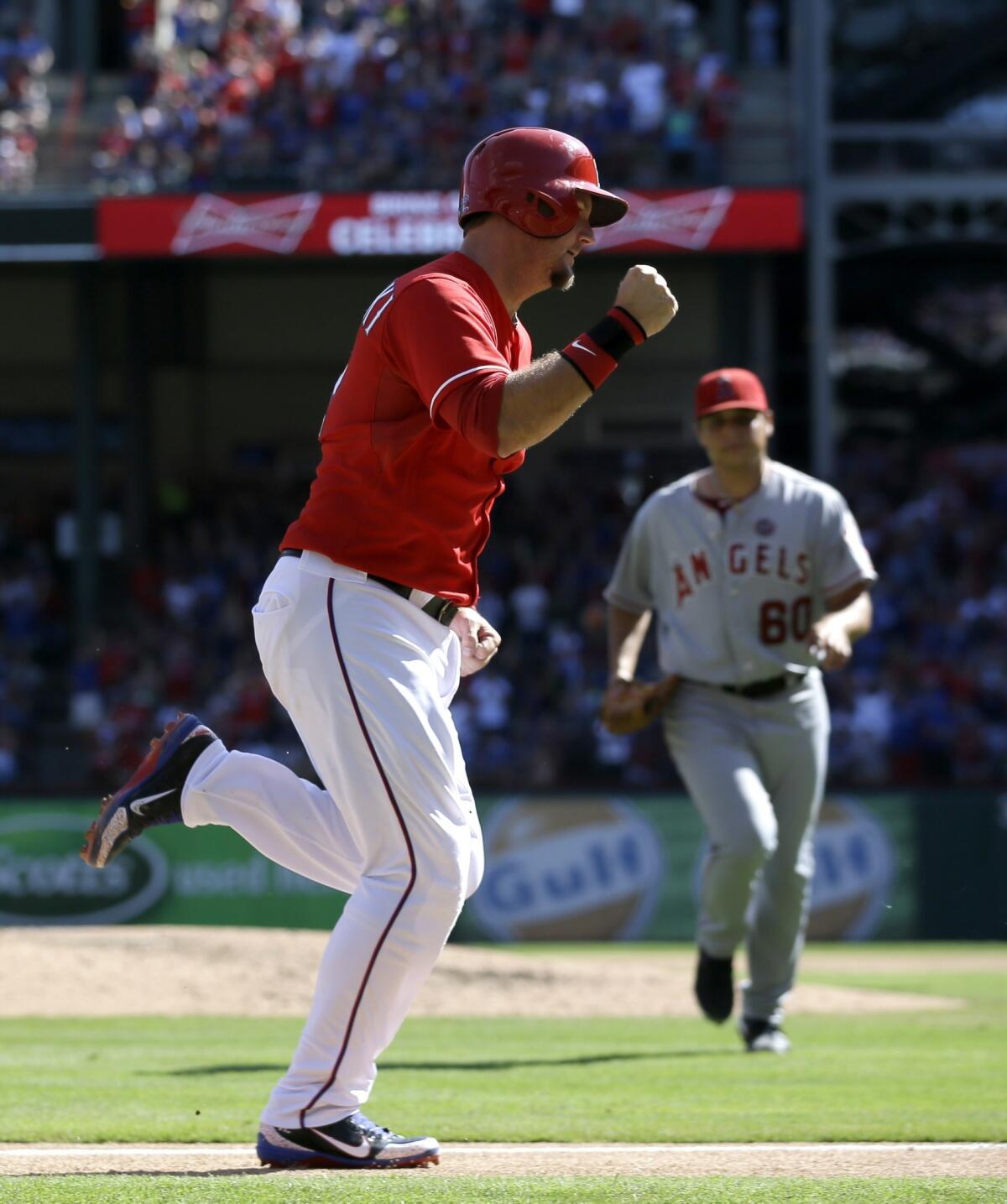 Texas designated hitter A.J. Pierzynski celebrates as he scores a run during the Angels' 6-2 loss Sunday.