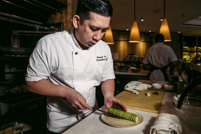 Chef David Tang preparing the first dish, Mangrove crab tartine which contains avocado,yuzu citrus and buck wheat. He is currently transferring the dish before garnishing it.