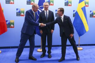 Turkey's President Recep Tayyip Erdogan, left, shakes hands with Sweden's Prime Minister Ulf Kristersson, right, as NATO Secretary General Jens Stoltenberg looks on prior to a meeting ahead of a NATO summit in Vilnius, Lithuania, Monday, July 10, 2023. (Yves Herman, Pool Photo via AP)