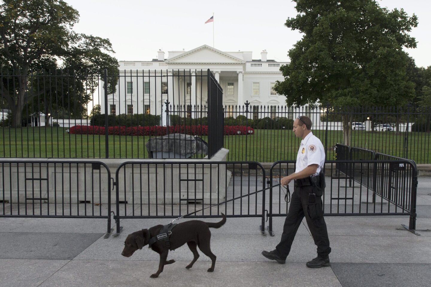 A member of the Secret Service walks on Pennsylvania Avenue outside the north fence of the White House.