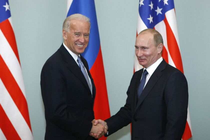 FILE - In this March 10, 2011, file photo, then-Vice President Joe Biden, left, shakes hands with Russian Prime Minister Vladimir Putin in Moscow, Russia. President Joe Biden has been thrown into a high-wire act with Russia as he seeks to toughen his administration's stance against Putin while preserving room for diplomacy in a post-Donald Trump era. (AP Photo/Alexander Zemlianichenko, File)