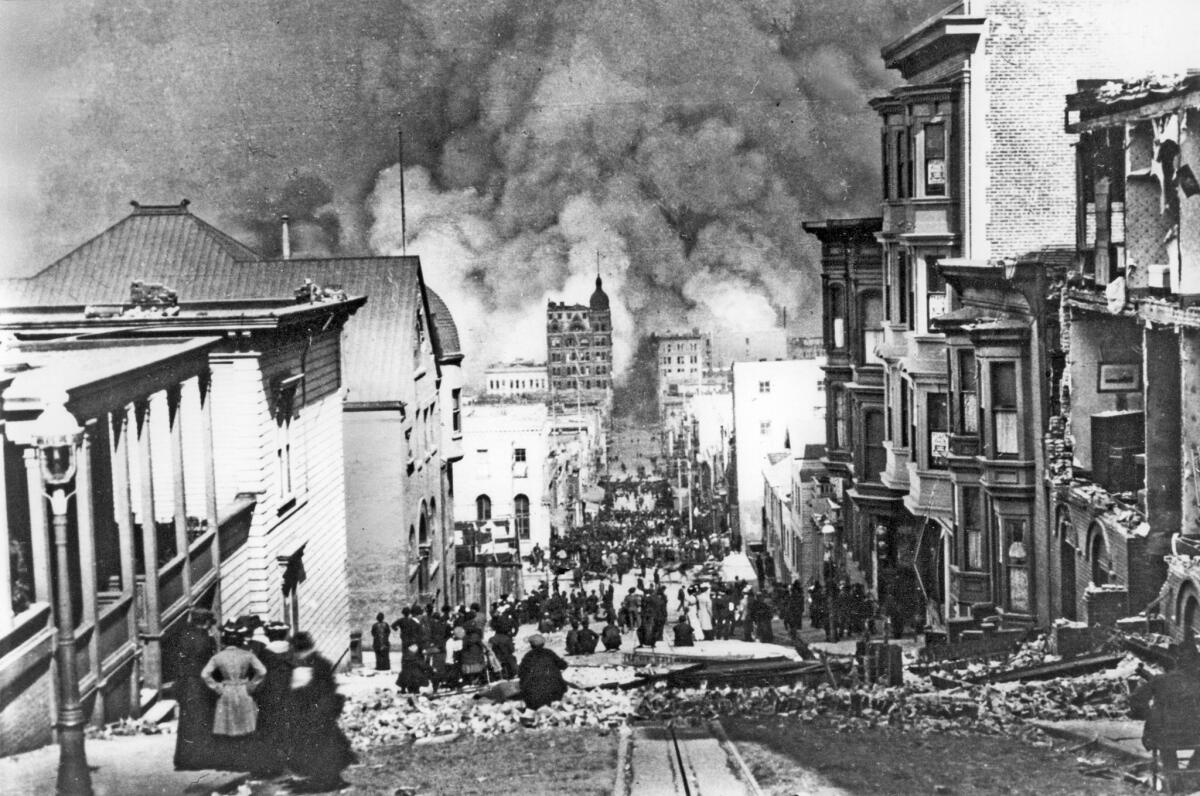 San Francisco earthquake 1906. Survivors of 1906 earthquake stand amid ruins on Sacramento Street watching fires that swept downtown. AP photo.