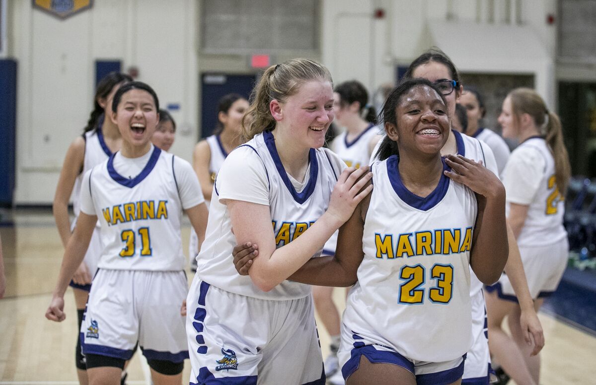 Marina's Sydnie Smith, left, celebrates with Rylee Bradley and fellow teammates after beating Lompoc. 
