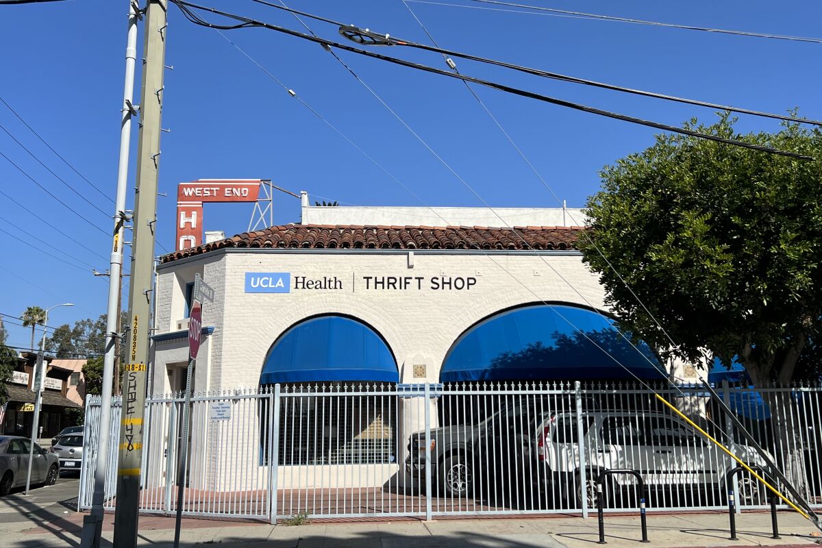 UCLA Thrift Shop stands on a corner behind a fence.