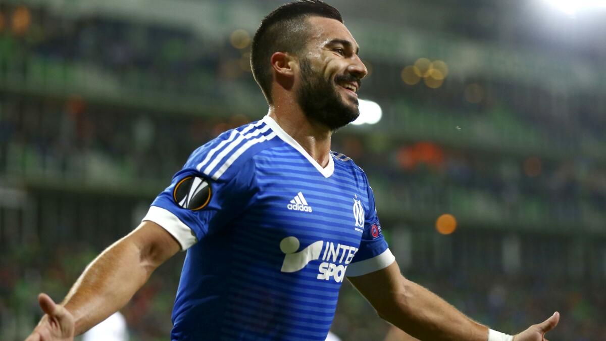 Romain Alessandrini celebrates after scoring for Marseille during a Europe League game.