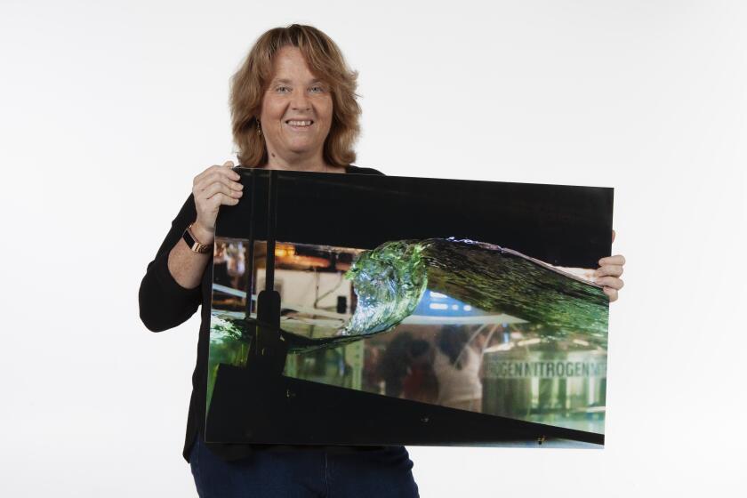 San Diego, California, USA January 1st, 2019 | Kimberly Prather is a professor of climate, atmospheric science, and physical oceanography at UC San Diego. She holds up a photo of a ocean wave created in the lab. | (Alejandro Tamayo, The San Diego Union Tribune 2019)
