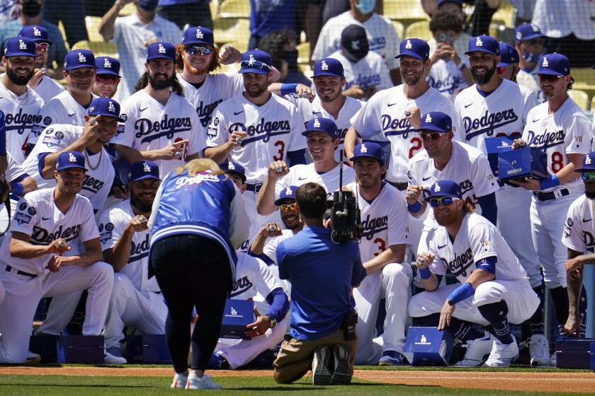 Dodgers players pose for photos with their 2020 World Series championship rings.