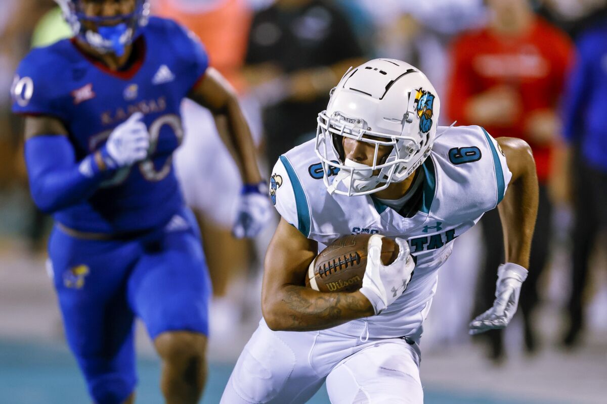 Coastal Carolina wide receiver Jaivon Heiligh, right, runs after a catch against Kansas during the second half of an NCAA college football game in Conway, S.C., Friday, Sept. 10, 2021. Coastal Carolina won 49-22. (AP Photo/Nell Redmond)
