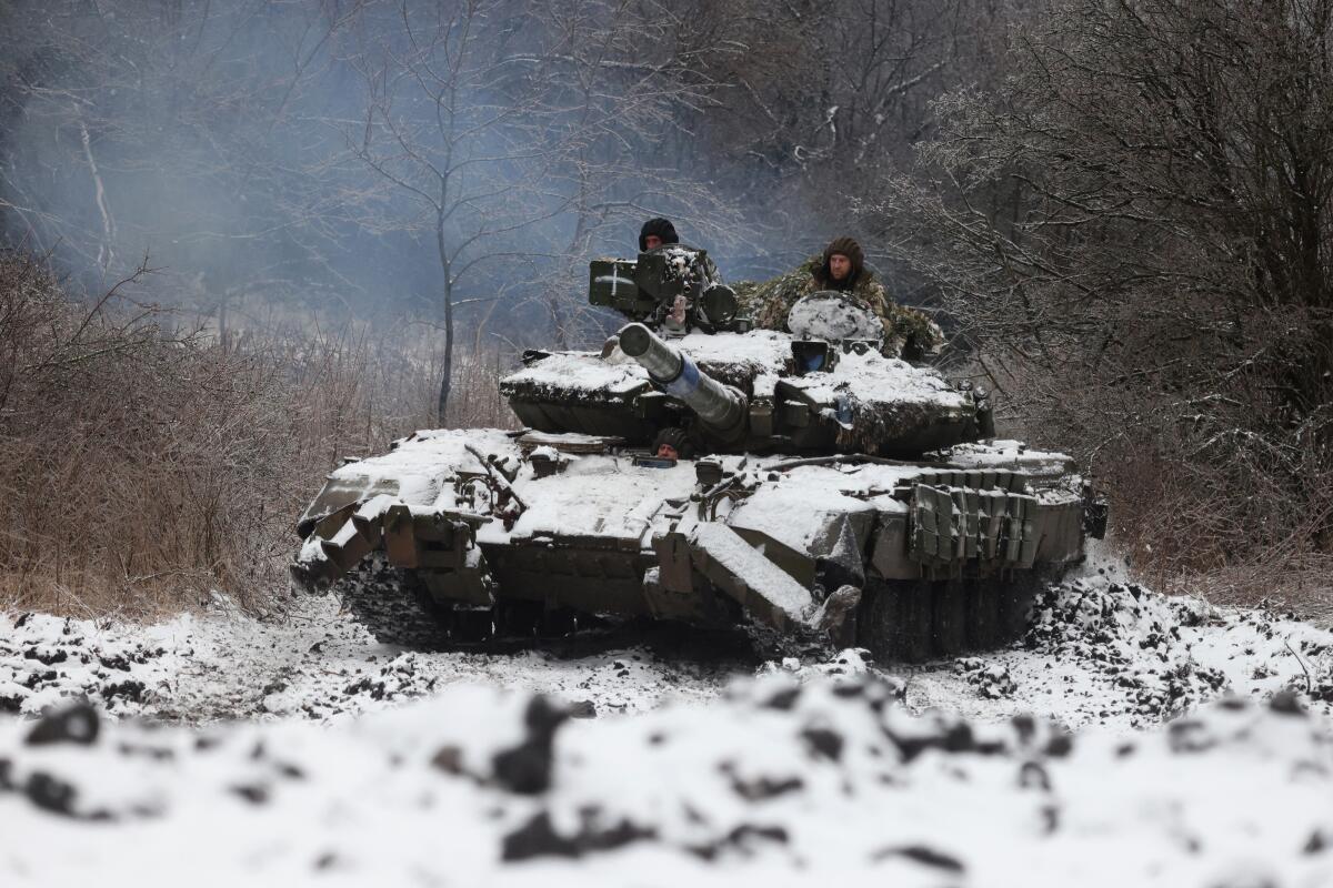 Soldiers with a tank covered in snow
