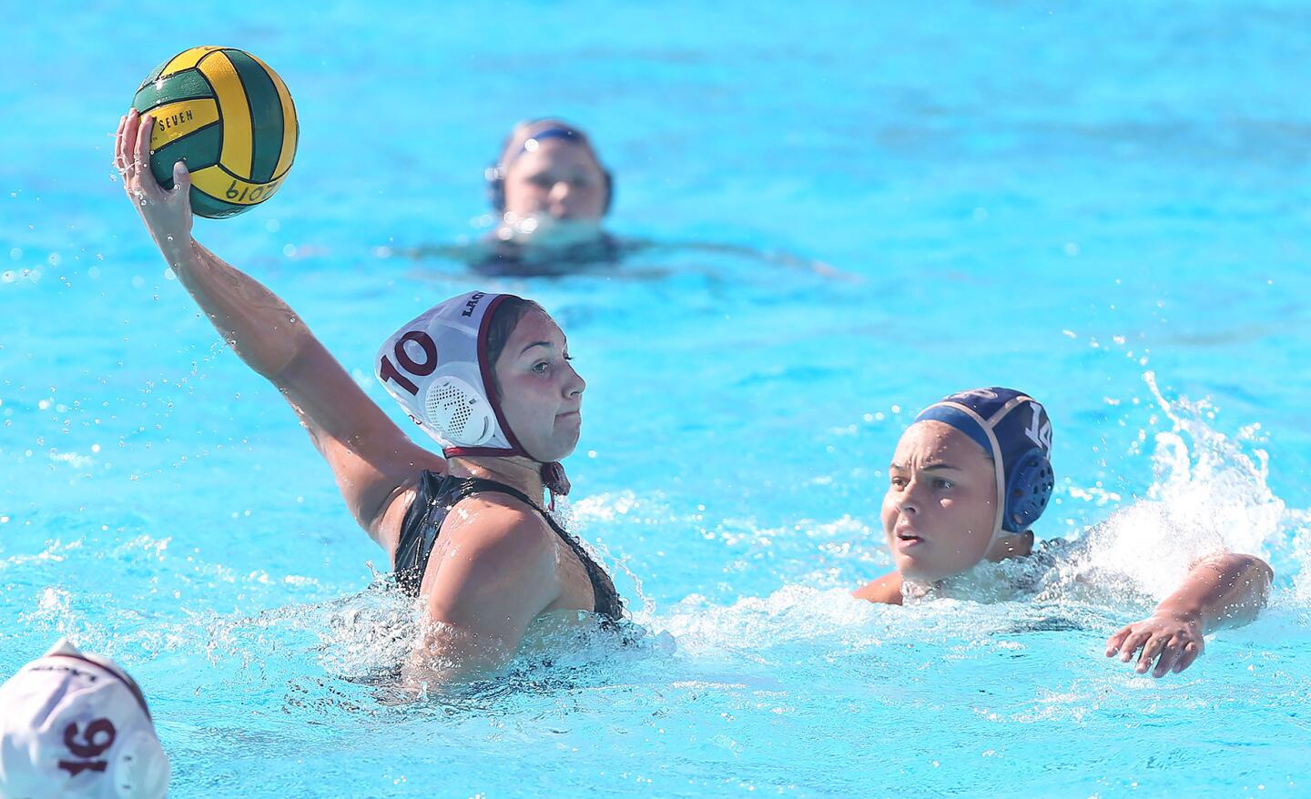 Laguna Beach High's Emma Lineback takes a long shot and scores as Dos Pueblos Abbi Hill can only look on during the semifinals of the Irvine Southern California Championships Tournament on Saturday.