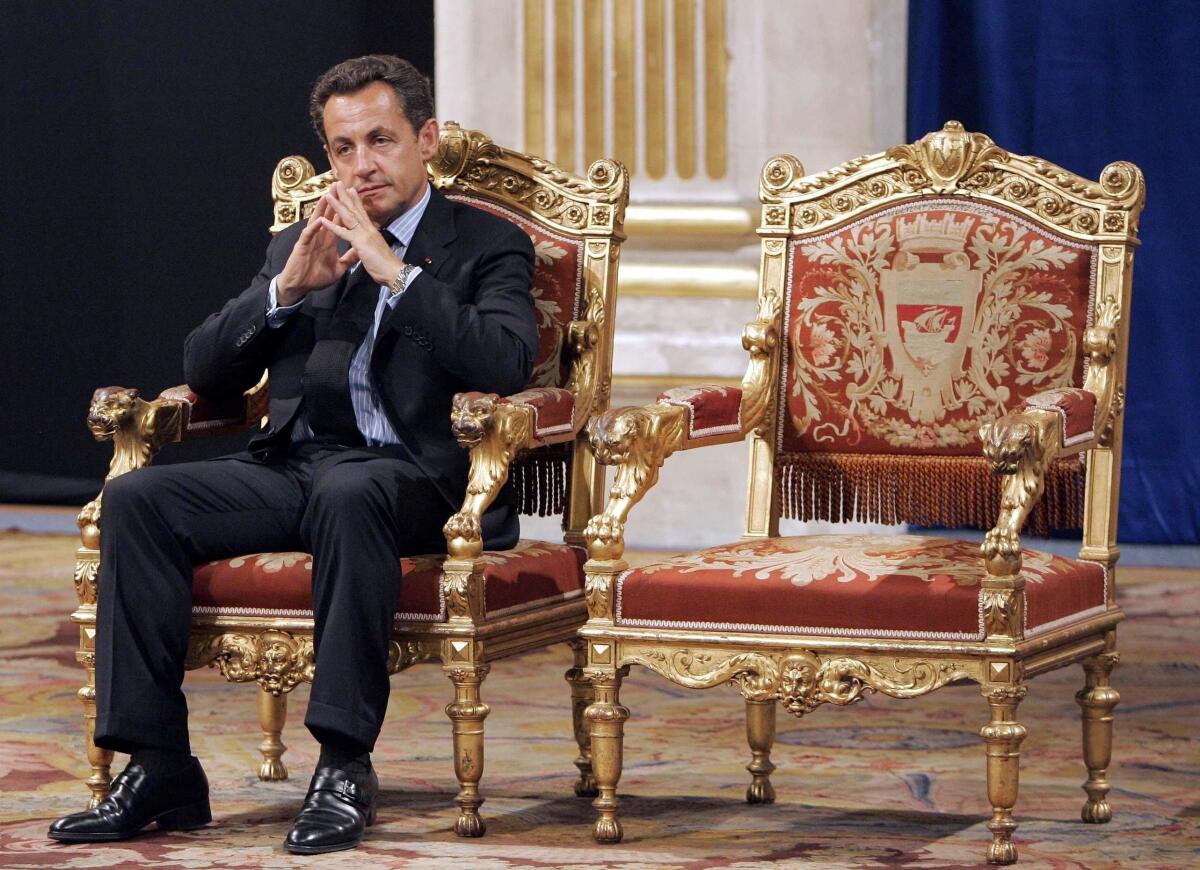 Former French President Nicolas Sarkozy on a throne-like chair