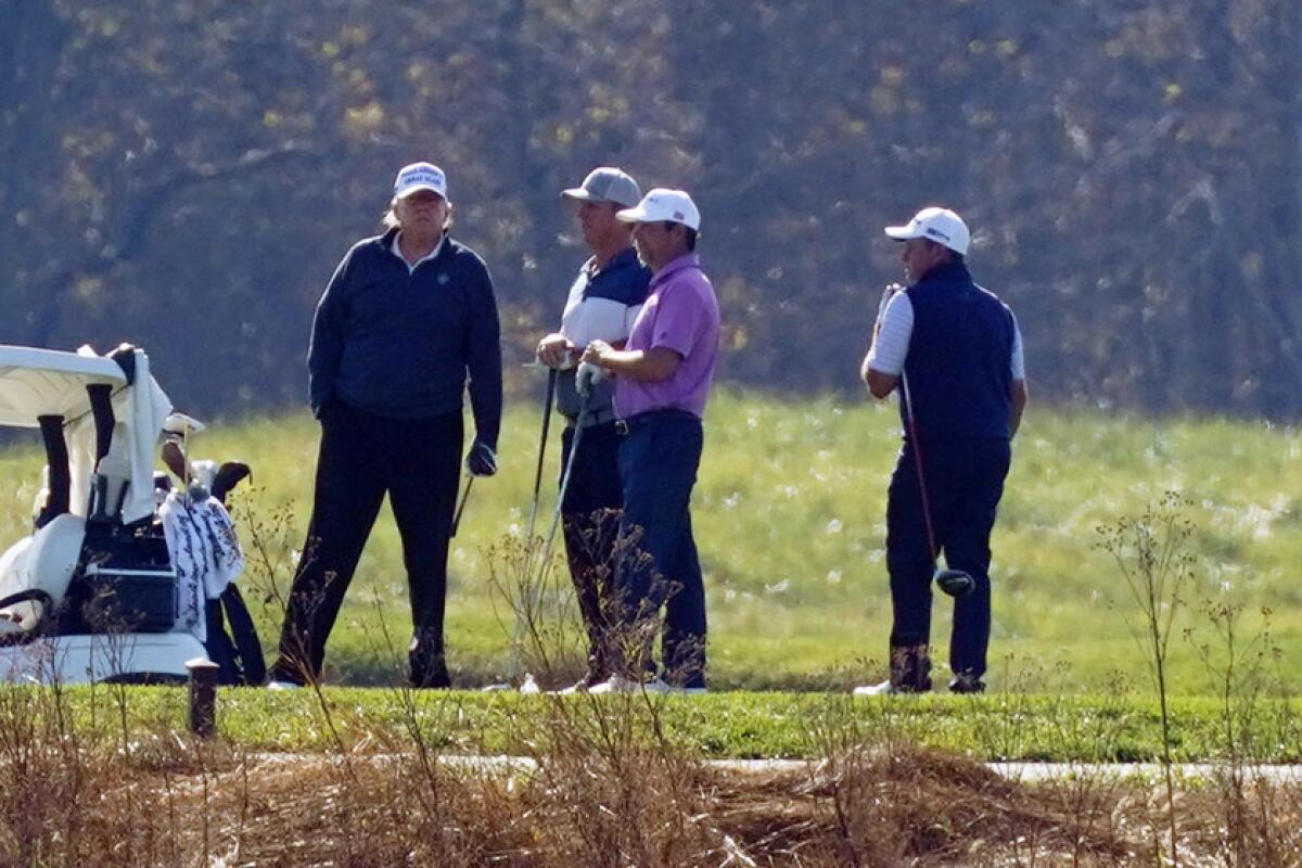 President Trump, left, golfs with others in Sterling, Va., on Nov. 7. 
