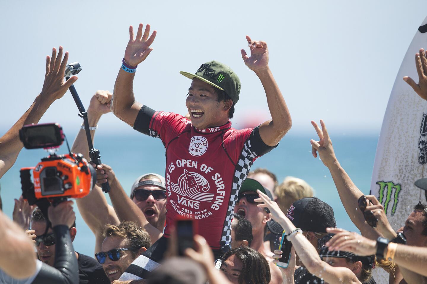 Hiroto Ohhara celebrates his victory with fans after winning the Vans U.S. Open of Surfing in Huntington Beach.