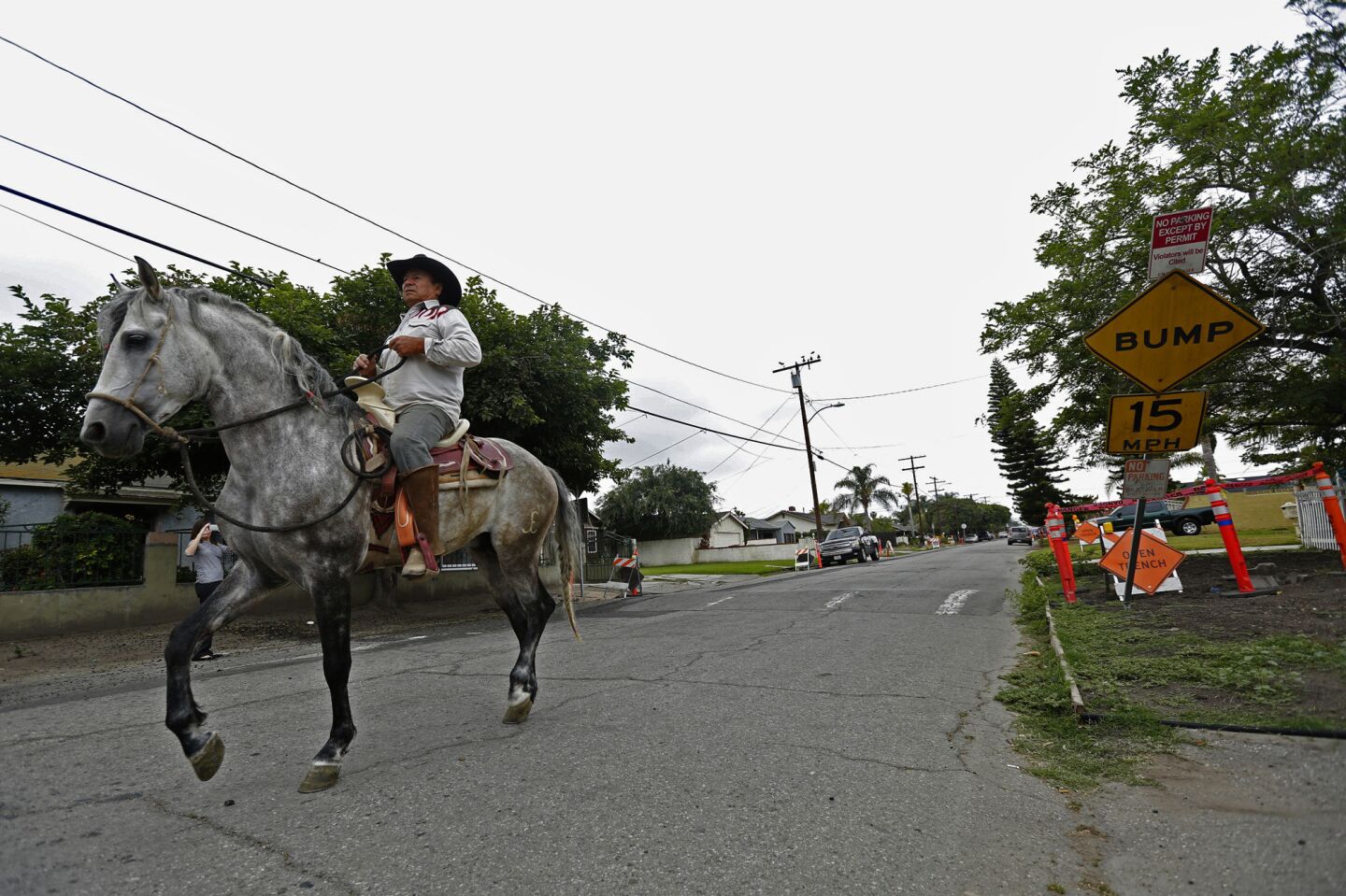 Jesus Sevilla rides his horse down West Caldwell Street where one of four killings occurred over the weekend of May 14-15, 2016, in Compton.