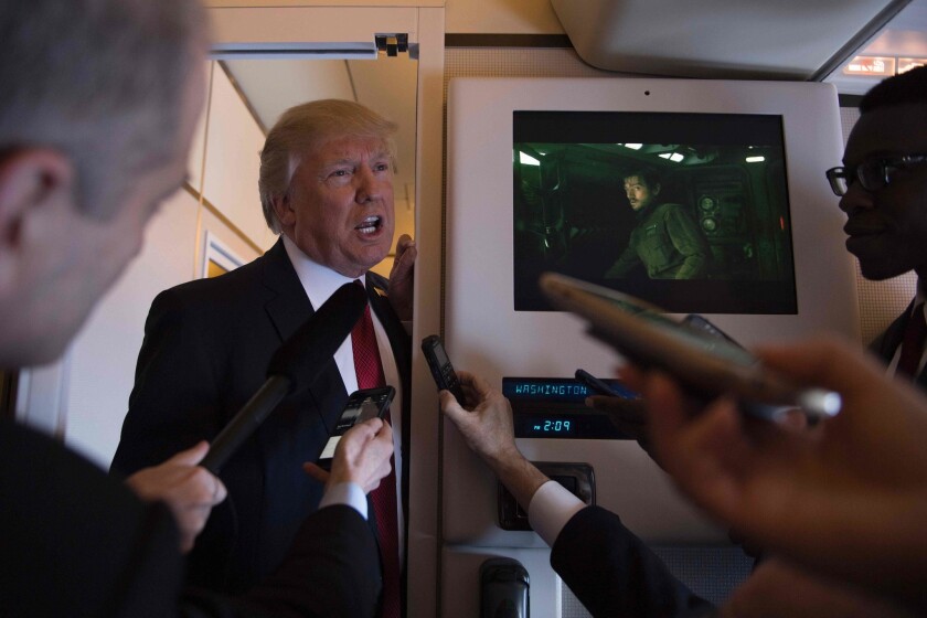President Trump speaks to reporters on Air Force One.