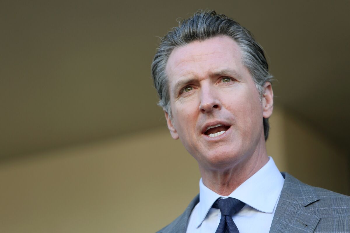Gov. Gavin Newsom speaks to members of the press after a meeting.