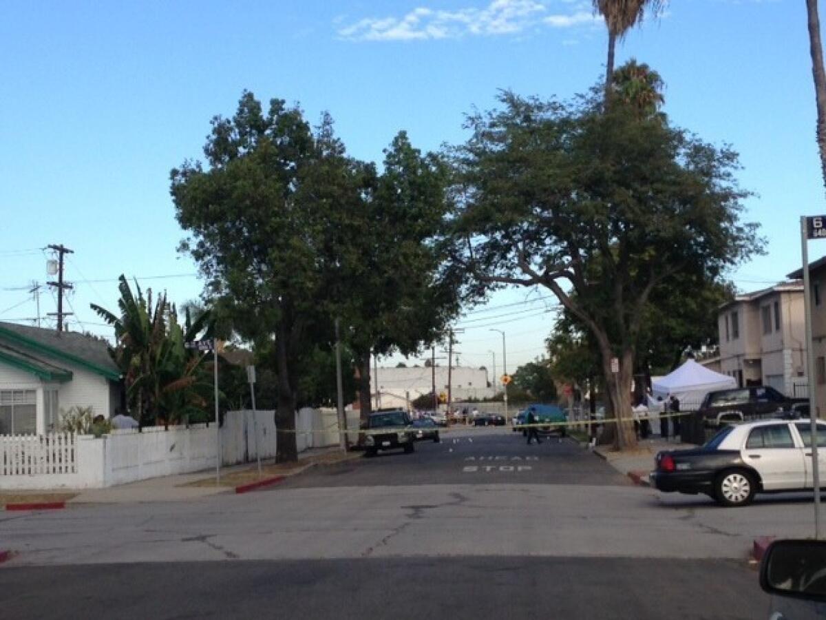Police tape marks the area where two people were killed in a shooting in South Los Angeles.