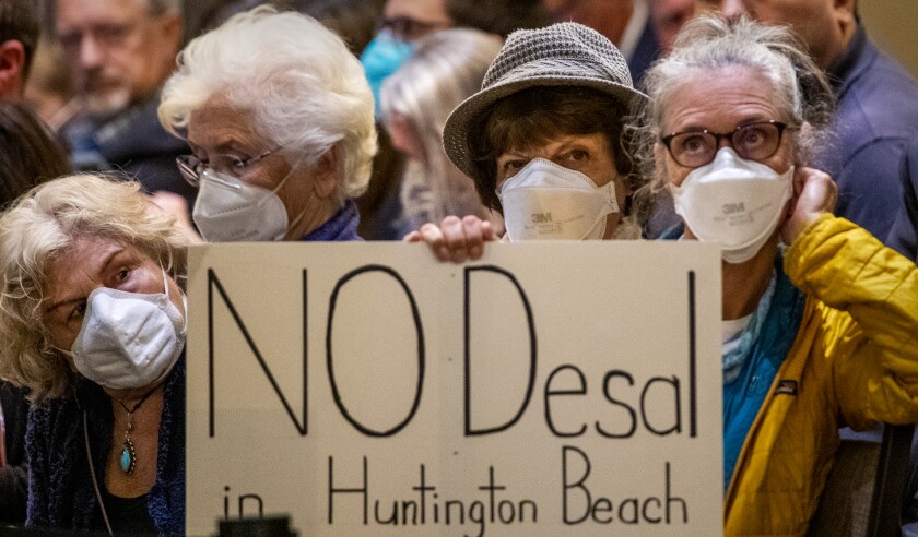 Spectators protest against proposed Poseidon desalination project in Huntington Beach