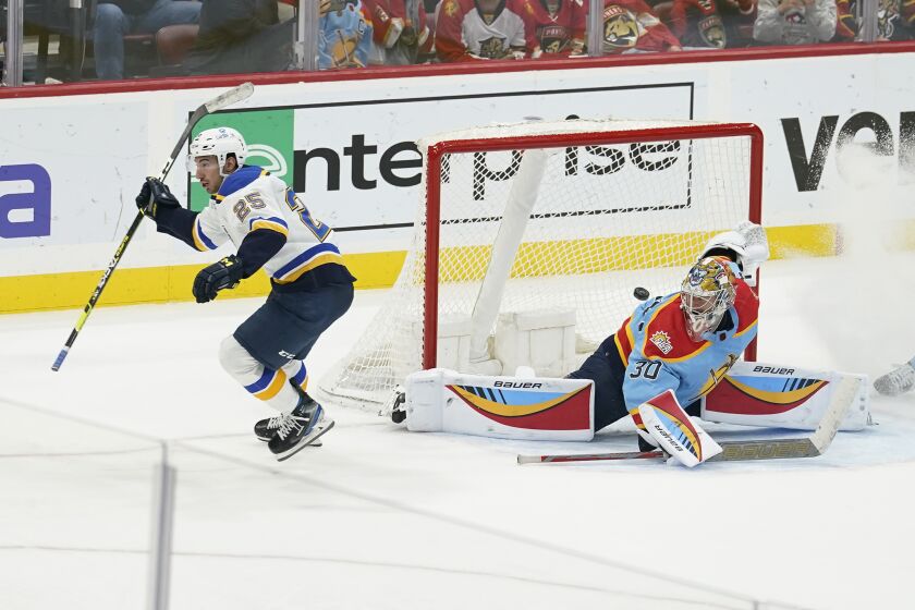 St. Louis Blues center Jordan Kyrou (25) scores the game winning goal against Florida Panthers goaltender Spencer Knight (30)during overtime of an NHL hockey game, Saturday, Nov. 26, 2022, in Sunrise, Fla. The Blues defeated the Panthers 5-4. (AP Photo/Marta Lavandier)