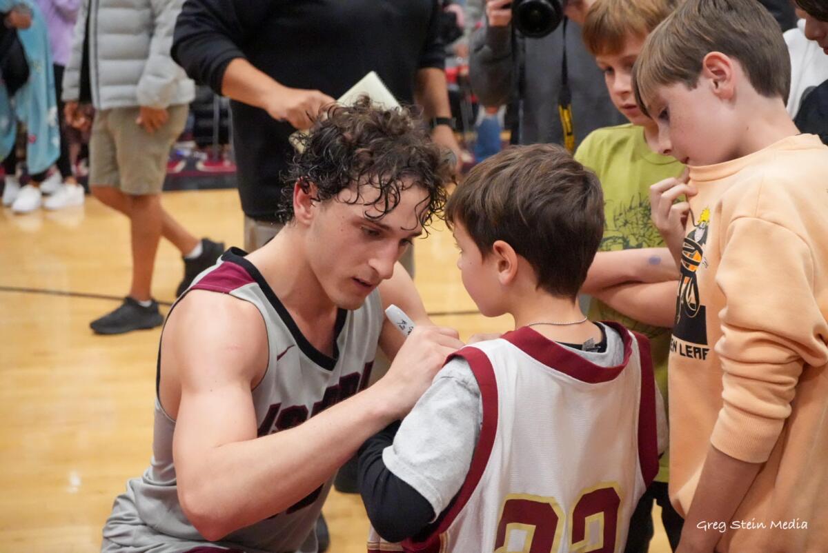 Aidan Fowler of JSerra signs an autograph after scoring 36 points in win over Mater Dei.