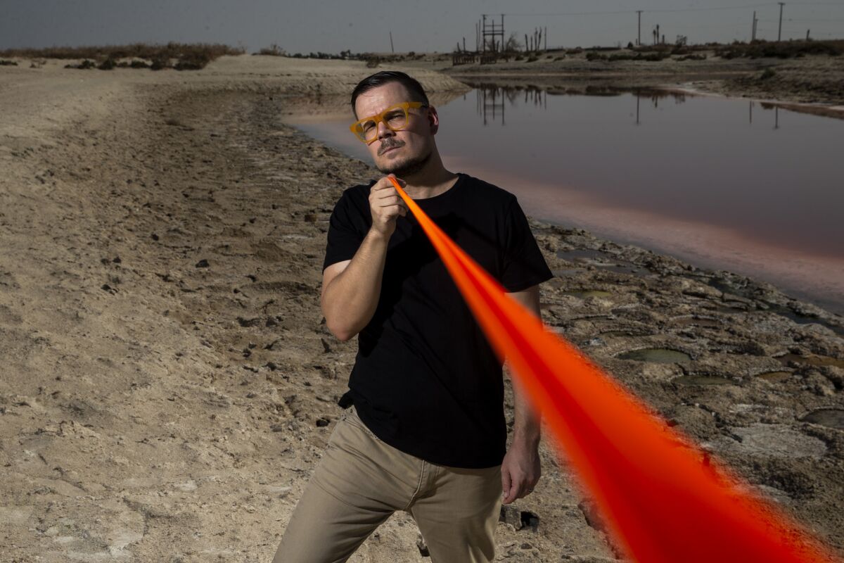 Environmental artist Cristopher Cichocki stands near the Anza Ditch in Salton City, Calif.