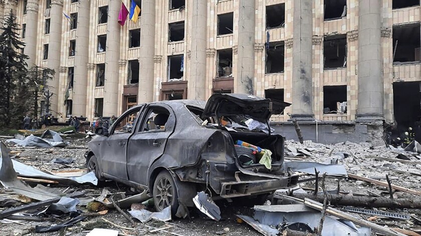 In this handout photo released by Ukrainian Emergency Service, a burnt car is seen in front of a damaged City Hall building, in Kharkiv, Ukraine, Tuesday, March 1, 2022. Russian shelling pounded civilian targets in Ukraine's second-largest city, Kharkiv, Tuesday and a 40-mile convoy of tanks and other vehicles threatened the capital - tactics Ukraine's embattled president said were designed to force him into concessions in Europe's largest ground war in generations. (Ukrainian Emergency Service via AP)